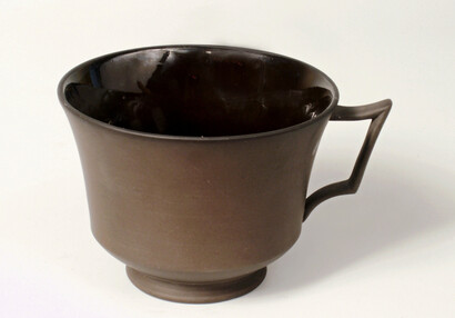 Tea cup from black earthenware
